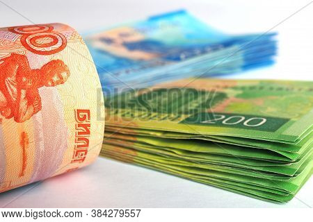 Russian Banknote 5000 Rubles And A Stack Of 2000 Banknotes And 200 Rubles Lie On A White Surface. Cl