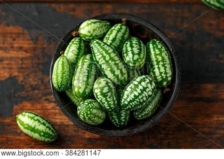 Freshly Picked Cucamelon In Rustic Bowl On Wooden Table
