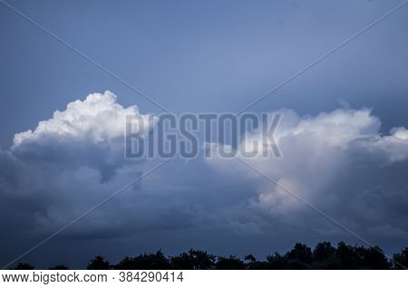Clouds At Sunset When It Is Almost Dark. White Clouds On A Dark Sky In The Evening