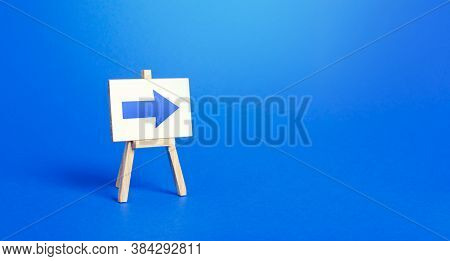 Easel With A Blue Right Arrow. Sign Of Direction. Advertising Of The Location Of A Store Or Outlet. 