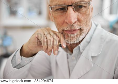 Medical Doctor Wearing Uniform And Loooking Focused