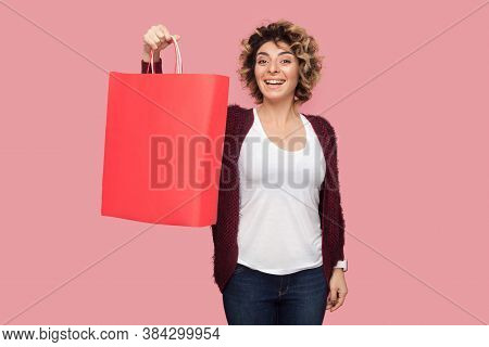 Wow! Satisfied Modern Young Woman In Blue Shirt With Curlty Hairstyle Standing And Showing Shopping