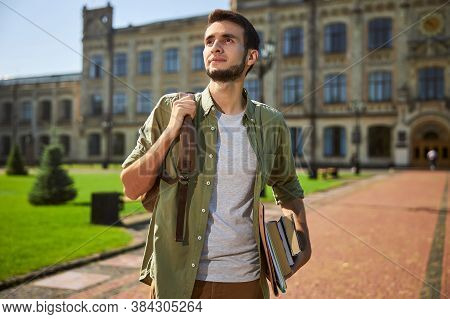 Dreamy Attractive Male Student Standing Alone Outdoors