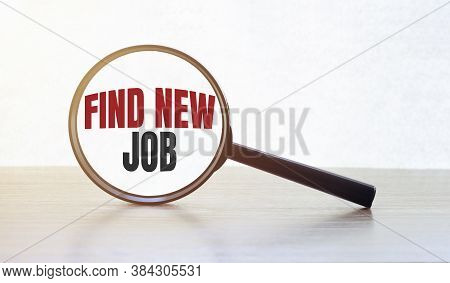 Magnifying Glass With Text Find New Job On Wooden Table.