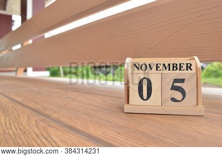 November 5, Number Cube With Wooden Balcony Background.