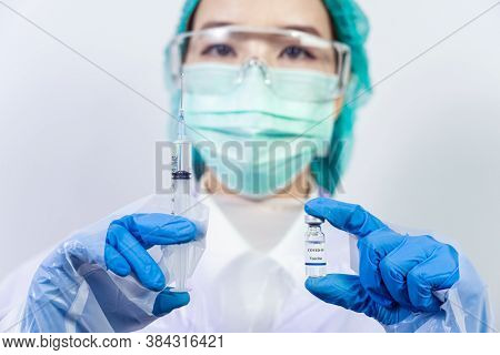 Doctor, Scientist, Researcher Hand In Blue Gloves Or Protective Suit Preparing For Human Clinical In
