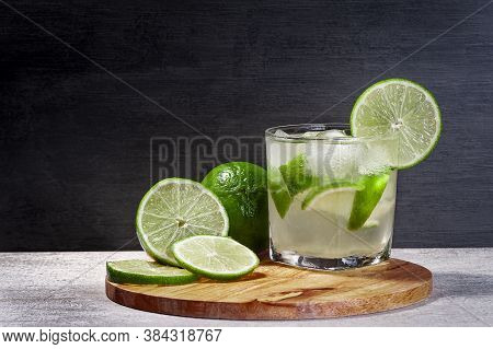 Brazilian Caipirinha On A Cutting Board With Lemon With A Gradient Background, Copy Space
