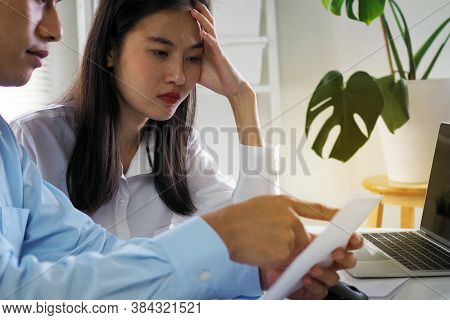 Asian Husband And Wife Are Stressed With The Bill. Loan Problems Causing A Lot Of Debt