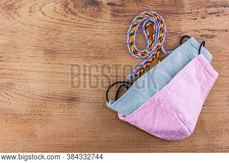 Face Mask With Neck Strap Placed On Wooden Floor.