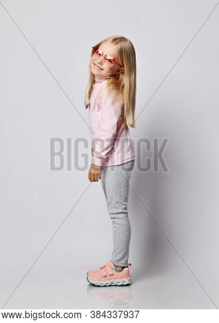 Cute Smiling Blonde Kid Girl In Stylish Smoked Heart-shaped Sunglasses And Wool Thermal Underwear Tu