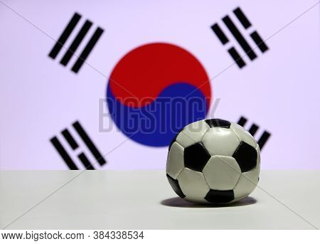Small Football On The White Floor With Out Focus Red And Blue Yin Yang And Four Black Trigrams Of So