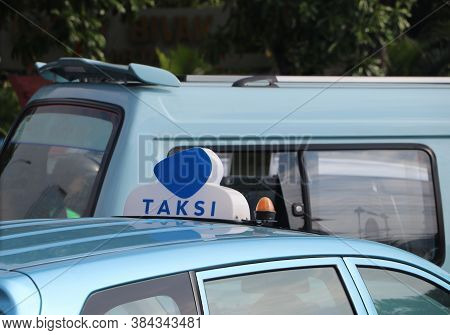 Taxi Light Sign Or Cab Sign In Blue And White Color On The Blue Color Of Car Roof At The Street, Wit