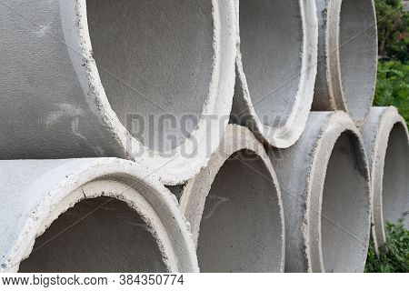 Close Up. Concrete Pipes Used For Drainage And Road Side In A Big City.