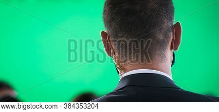 Security Guard Listening To His Earpiece On Event. Back Of Jacket Showing. Secret Service Guard. Pri