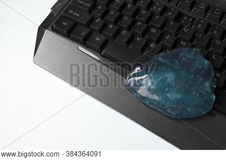 Blue Soft Gel Cleaning Dust On Keyboard. Concept Cleaning Your Computers Keyboard. Office Cleaning.