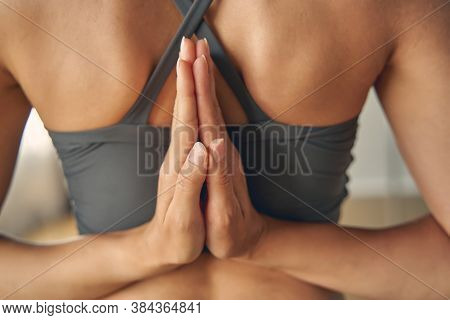 Female Yoga Instructor Doing Reverse Prayer Pose