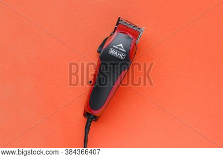 Kharkov, Ukraine - July 2, 2020 : Hairdressers Tool. Hair Clipper Wahl Close-up On A Red Background.
