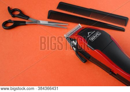 Kharkov, Ukraine - July 2, 2020 : Hairdressers Tool. Hair Clipper Wahl Close-up On A Red Background 