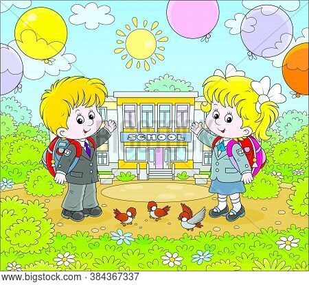 The First Of September. Happy Schoolchildren With Schoolbags And Colorful Balloons Standing In Front