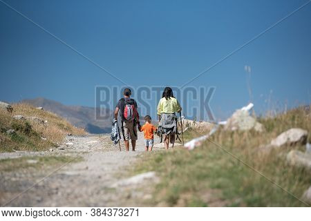 Family Walk In Sunny Day In Els Cortals De Encamp On Andorra, Pyrennes Mountians.