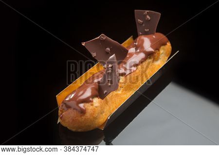 Ecler Chocolate Dessert With Chocolate Glaze On Black Background.