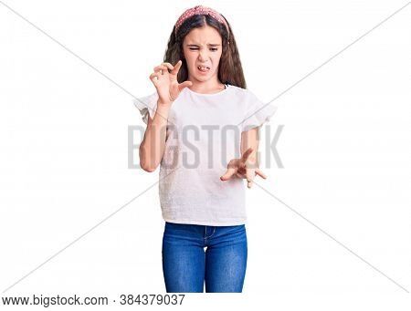 Cute hispanic child girl wearing casual white tshirt disgusted expression, displeased and fearful doing disgust face because aversion reaction. 