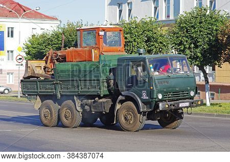 Orsha, Belarus - August 16, 2013: Kamaz-4310 Transports A Tractor On The Road To Orsha