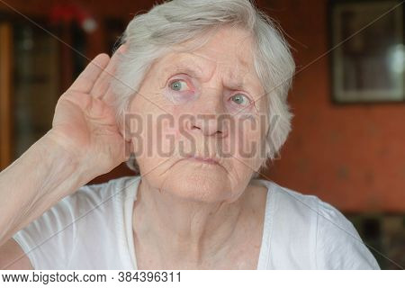 Senior Woman Holding Hand To Ear. Old Lady Having Hearing Problems. Portrait Of Grandmother Trying T