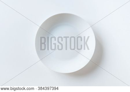 Empty Ceramic Round Plate Isolated On White Background. White Plate Placed On White Background. Top 