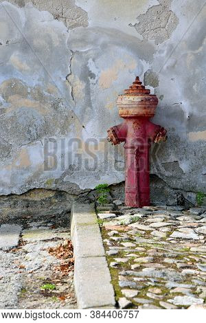 Old Red Fire Hydrant With Grunge Texture Wall Background
