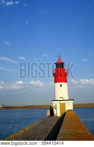 Lighthouse At The Entrance Of The Harbour