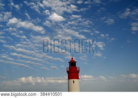 Lighthouse At The Entrance Of The Harbour
