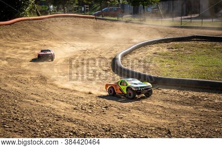 Two Offroad Rc Cars Racing On A Track