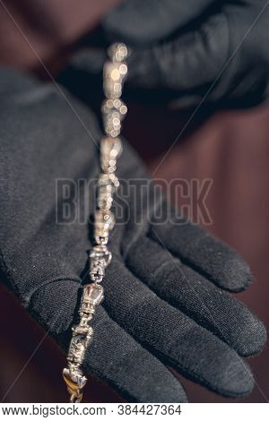 Master Holding A Piece Of Jewelry On His Palm