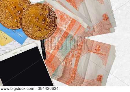 3 Cuban Pesos Convertibles Bills And Golden Bitcoins With Smartphone And Credit Cards. Cryptocurrenc