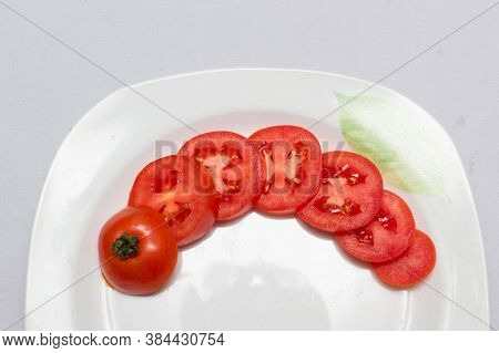 juicy red tomatoes in table cloth . caro background