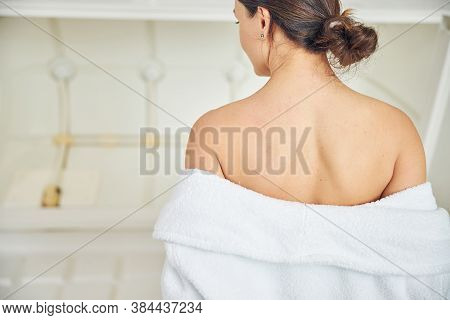 Back Of Young Woman Standing In Beauty Center