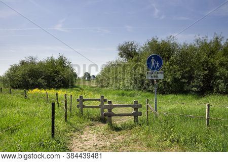 Footpath Leading Through A Gate And Through Some Trees To The River Waal Near The Dutch Village Ocht