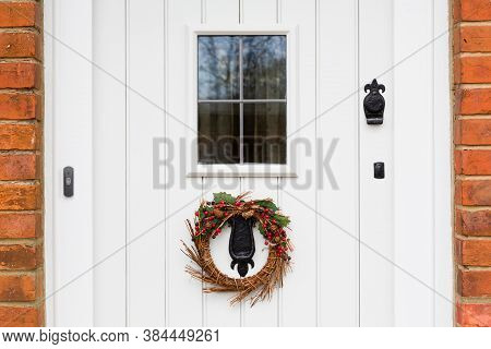Closeup Detail Of An English Offwhite, Off White Painted Timber Wood Door With A Christmas Wreath. E