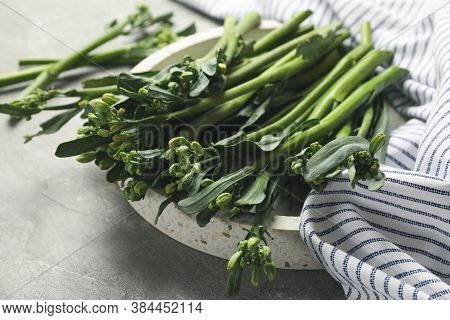 Tray With Broccolini And Napkin On Gray Background