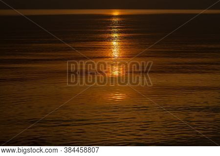 Sun Trail In Water During Sunset Over Sea
