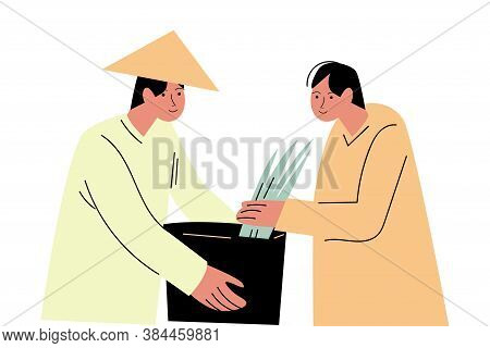 Two Asian Men Farmers In Special Costumes Picking Rice And Putting In Basket
