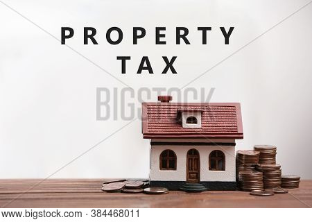 Text Property Tax Near Coins And House Model On Light Background