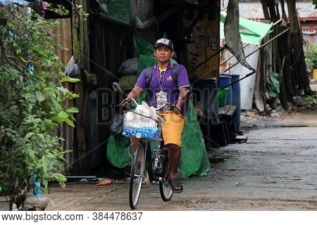 Yangon, Myanmar June 11, 2018: The Man Of Myanmarese Ride A Bicycle On The Alley Of Street In Yangon