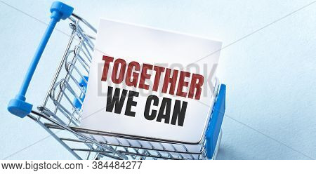 Shopping Cart And Text Together We Can On White Paper Note List. Shopping List Concept On Blue Backg