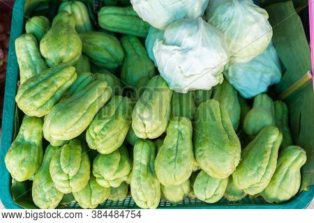 Fresh Chayotes (sechium Edule) Piled On Table In Stall Market. Pile Of Chayote Fruits. Fresh Vegetab
