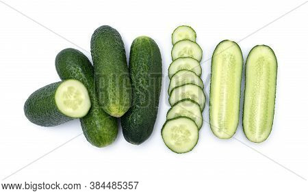 Group Of Fresh Little Cucumber. Mix Of Whole, Chopped And Sliced Cucumbers Isolated On Wite Backgrou