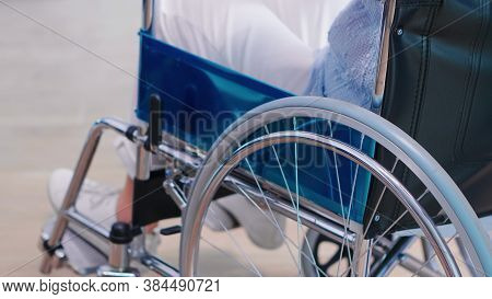 Disabled Old Woman Holding Hands On Chair Wheell In Hospital Hallway. Disabled Disability Handicappe