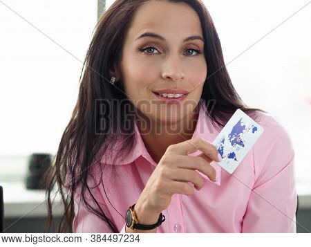 Portrait Of Attractive Young Woman Holding White Plastic Credit Card. Pretty Female In Pink Blouse P