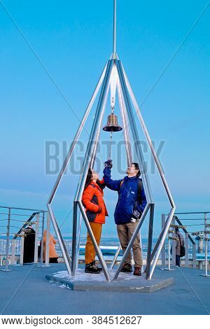 Sapporo, Hokkaido, Japan - December 2019 : A Love Couple Ringing The Bell At Top Of Mt. Moiwa In Sap